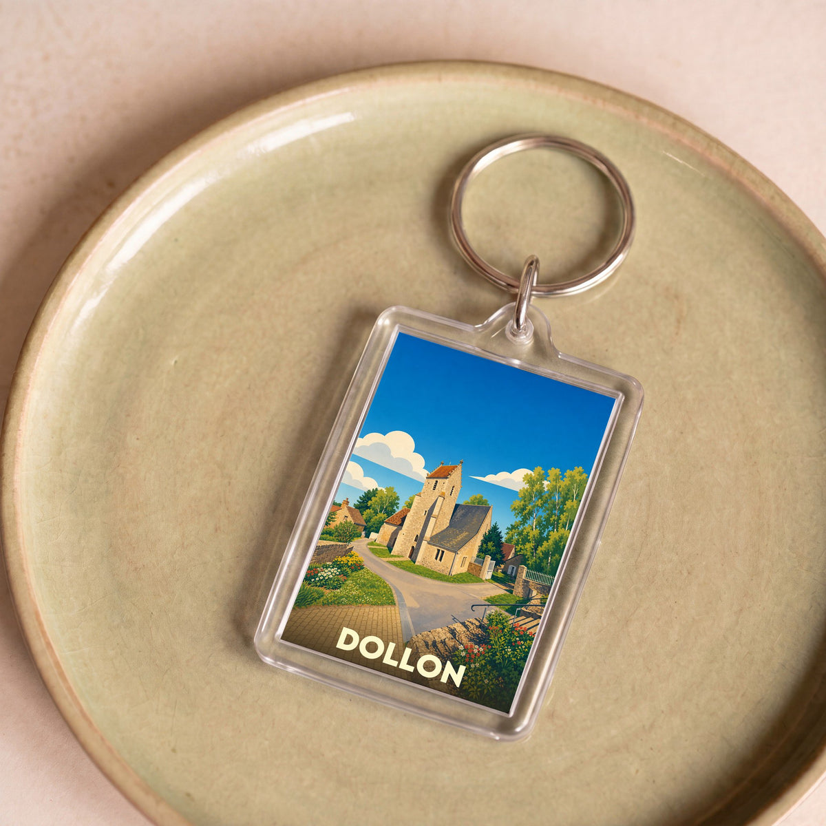 Porte-clés souvenir de la ville de Dollon avec une illustration stylisée.