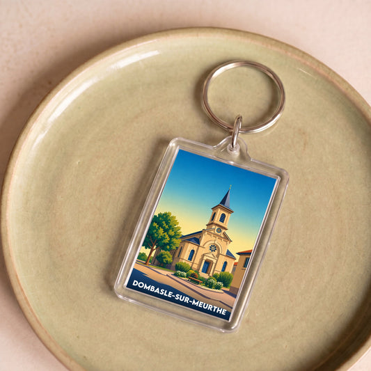 Porte-clés souvenir de la ville de Dombasle-sur-Meurthe avec une illustration stylisée de son église.