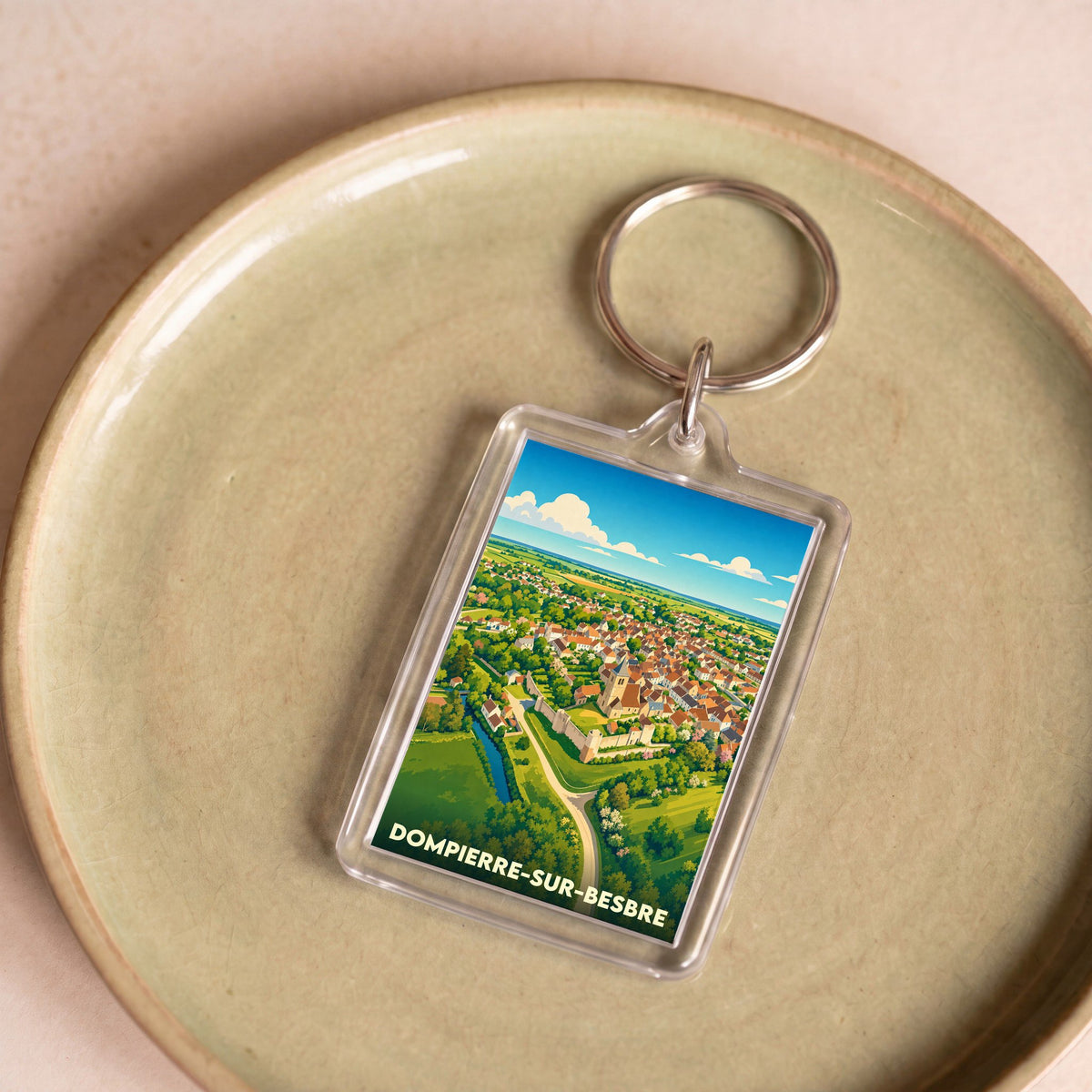 Porte-clés souvenir de la ville de Dompierre-sur-Besbre avec une illustration stylisée.