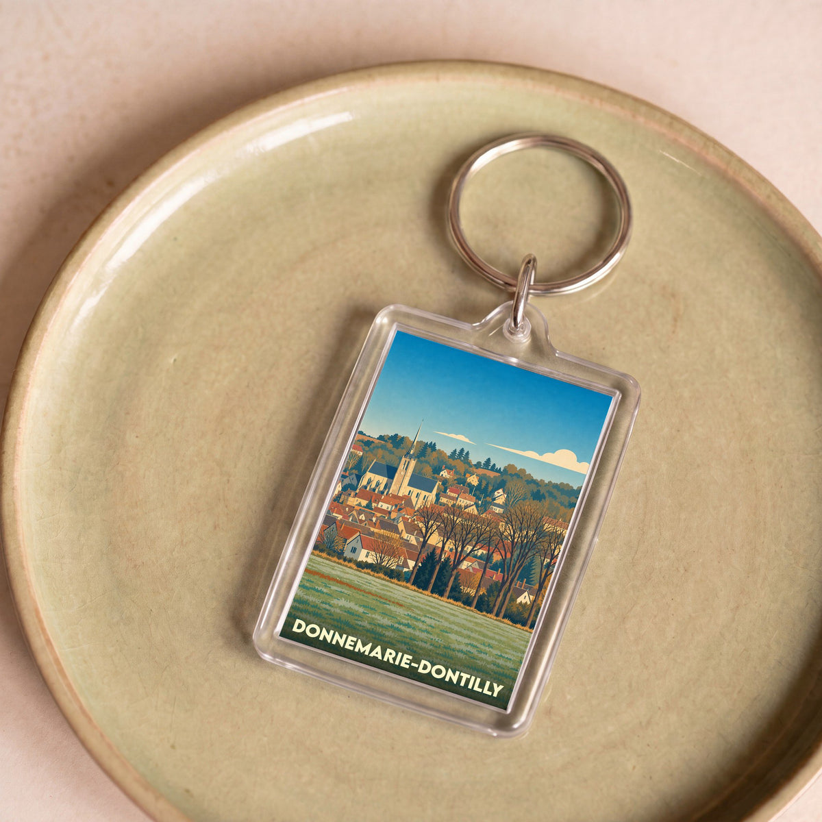 Porte-clés souvenir de la ville de Donnemarie-Dontilly avec une illustration stylisée.
