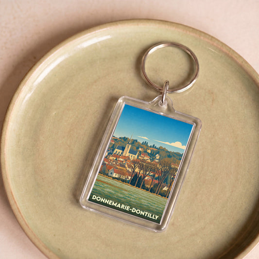 Porte-clés souvenir de la ville de Donnemarie-Dontilly avec une illustration stylisée.
