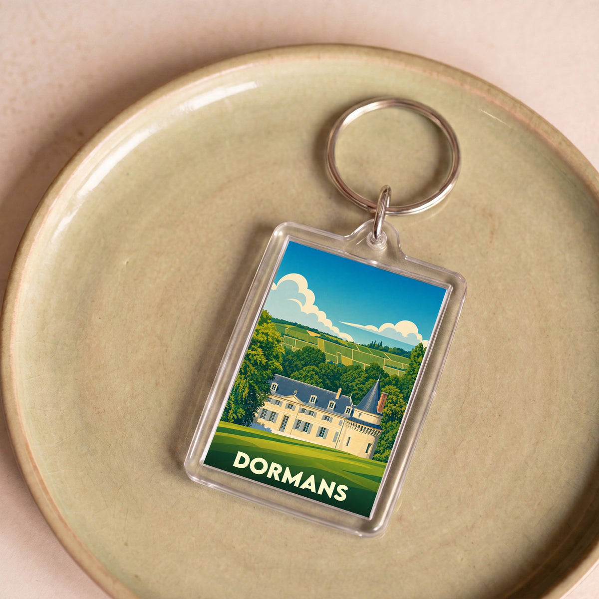 Porte-clés souvenir de la ville de Dormans avec une illustration stylisée.