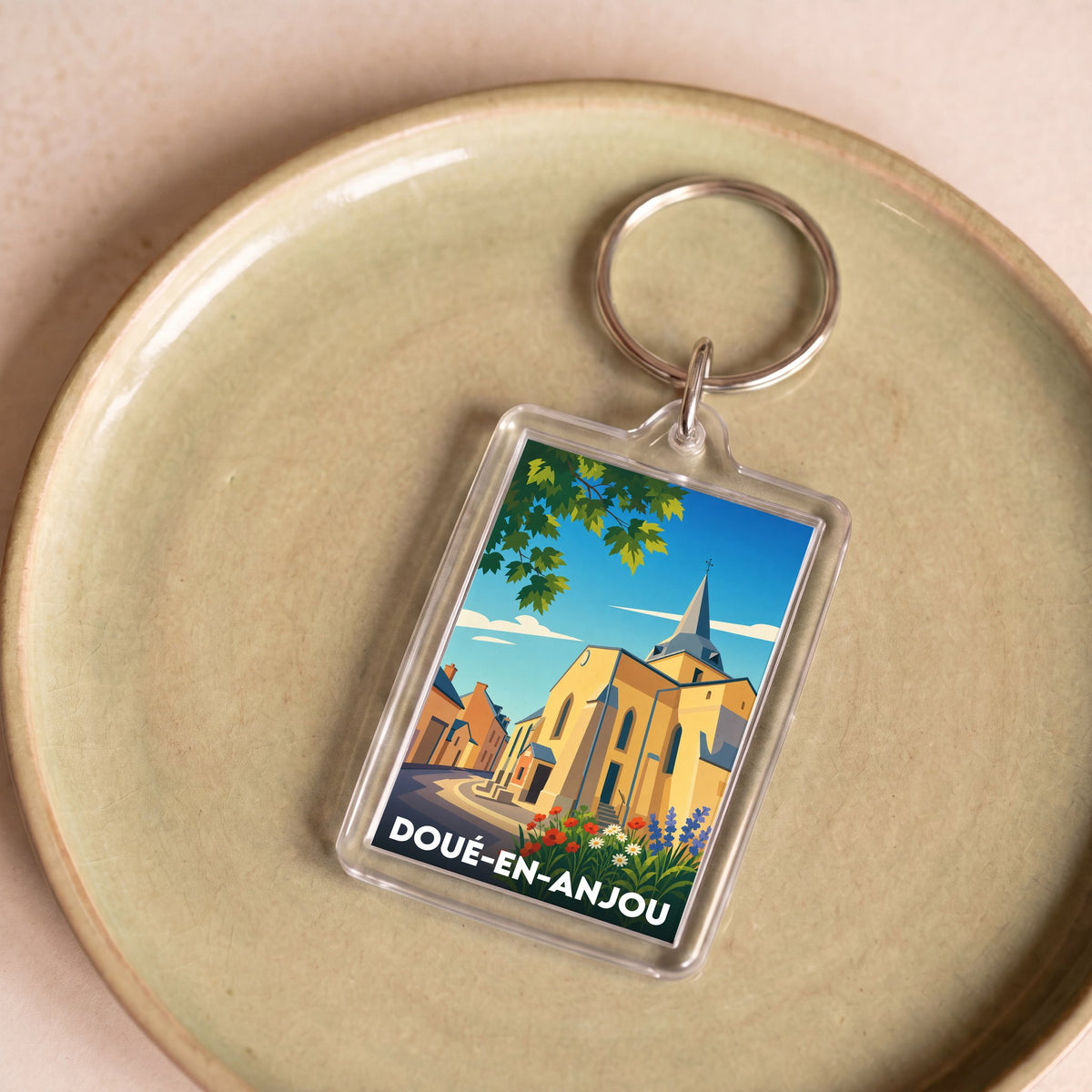 Porte-clés souvenir de la ville de Doué-en-Anjou avec une illustration stylisée.