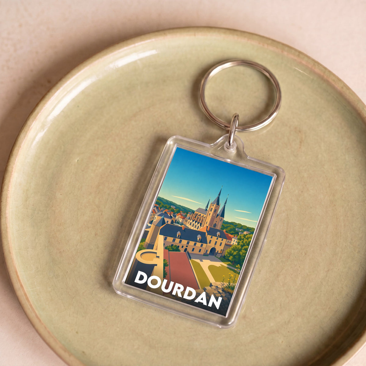 Porte-clés souvenir de la ville de Dourdan avec une illustration stylisée.