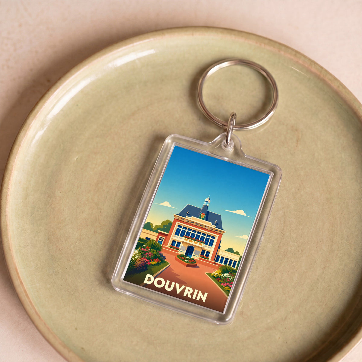 Porte-clés souvenir de la ville de Douvrin avec une illustration stylisée de son hôtel de ville.