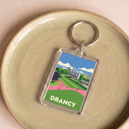 Porte-clés souvenir de la ville de Drancy avec une illustration stylisée.