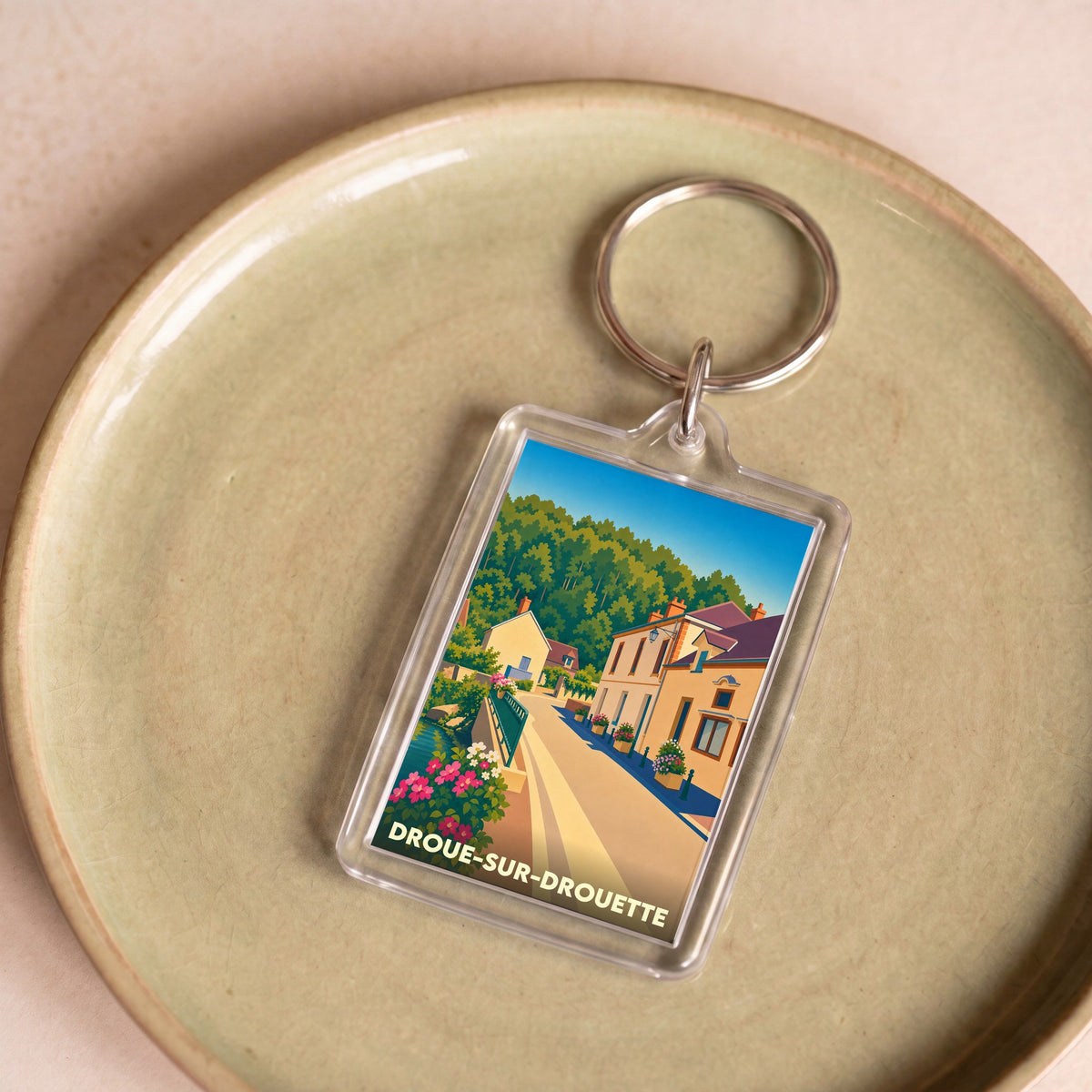 Porte-clés souvenir de la ville de Droue-sur-Drouette avec une illustration stylisée.