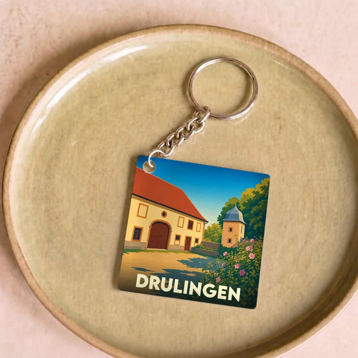 Porte-clés souvenir de la ville de Drulingen avec une illustration stylisée.