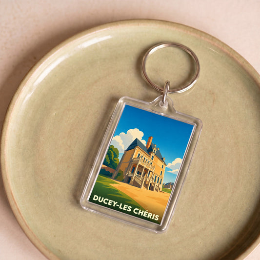 Porte-clés souvenir de la ville de Ducey-Les Chéris avec une illustration stylisée de son château.