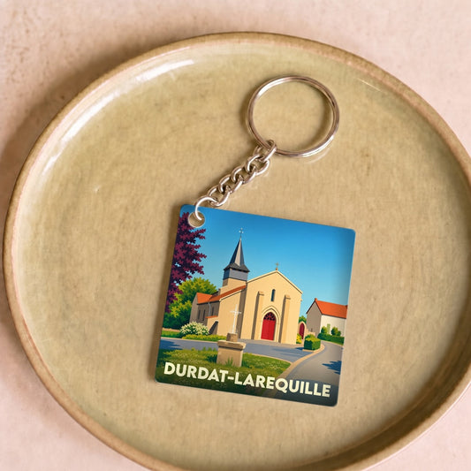 Porte-clés souvenir de la ville de Durdat-Larequille avec une illustration stylisée de son église.