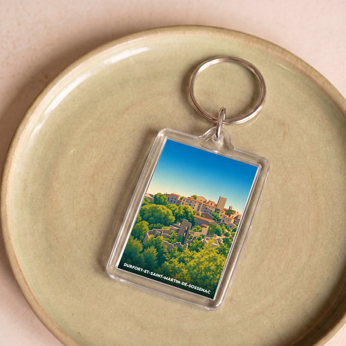 Porte-clés souvenir de la ville de Durfort-et-Saint-Martin-de-Sossenac avec une illustration stylisée.