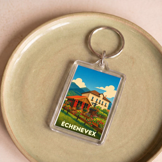 Porte-clés souvenir de la ville d'Échenevex avec une illustration stylisée d'un paysage de montagne.