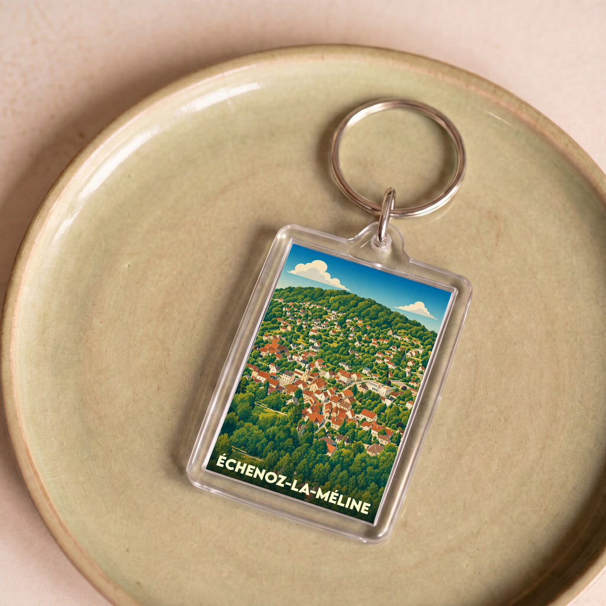 Porte-clés souvenir de la ville de Échenoz-la-Méline avec une illustration stylisée.