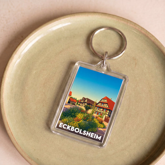 Porte-clés souvenir de la ville de Eckbolsheim avec une illustration stylisée de maisons à colombages.