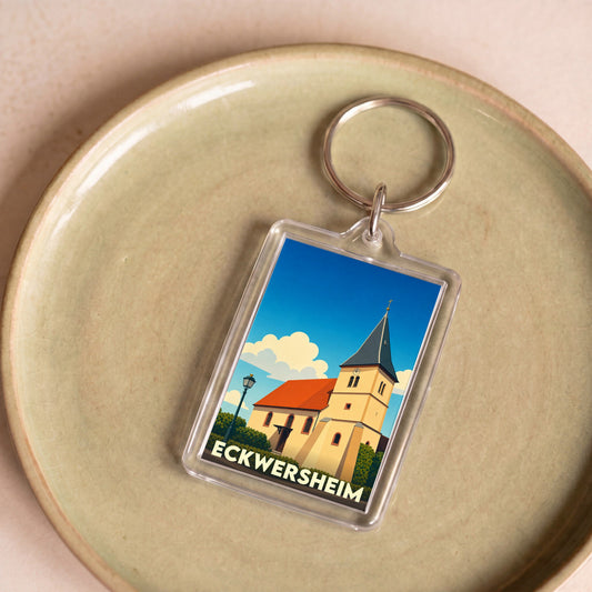 Porte-clés souvenir de la ville de Eckwersheim avec une illustration stylisée de son église sous un ciel bleu.