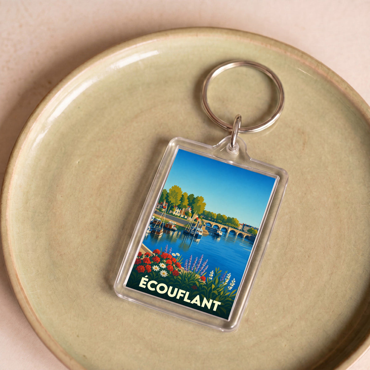 Porte-clés souvenir de la ville d'Écouflant avec une illustration stylisée des bords de la Sarthe.