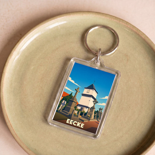 Porte-clés souvenir de la ville d'Eecke avec une illustration stylisée de son église et de son cimetière.