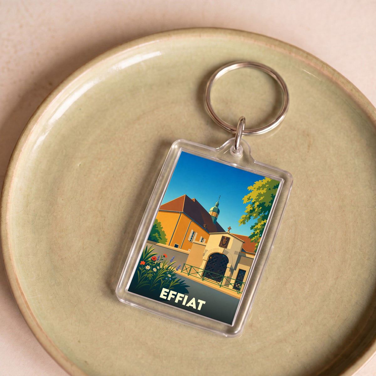 Porte-clés souvenir de la ville d'Effiat avec une illustration stylisée.