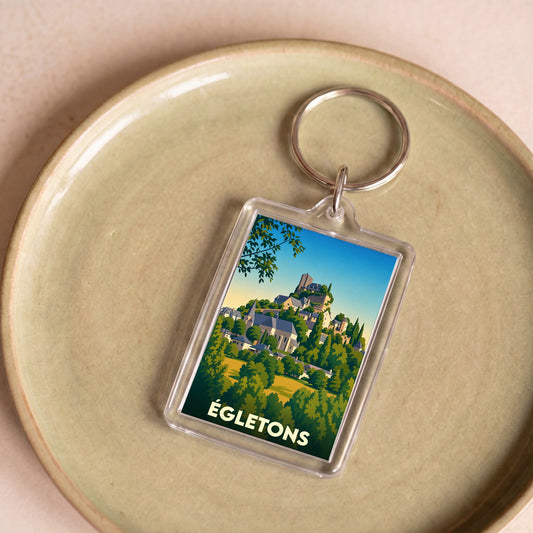 Porte-clés souvenir de la ville de Égletons avec une illustration stylisée.