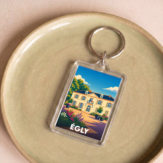 Porte-clés souvenir de la ville d'Égly avec une illustration stylisée.