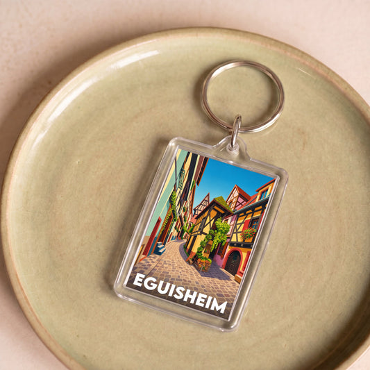 Porte-clés souvenir de la ville d'Eguisheim avec une illustration stylisée.