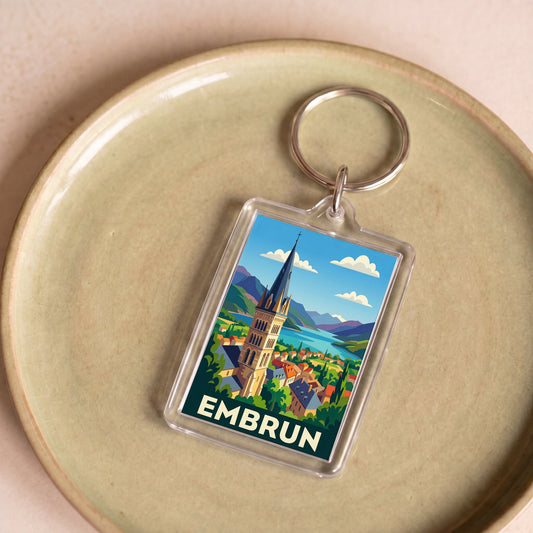 Porte-clés souvenir de la ville d'Embrun avec une illustration stylisée.