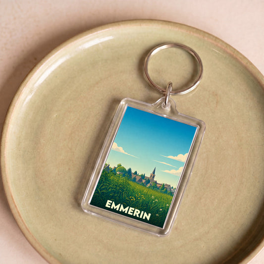 Porte-clés souvenir de la ville d'Emmerin avec une illustration stylisée de son paysage champêtre.
