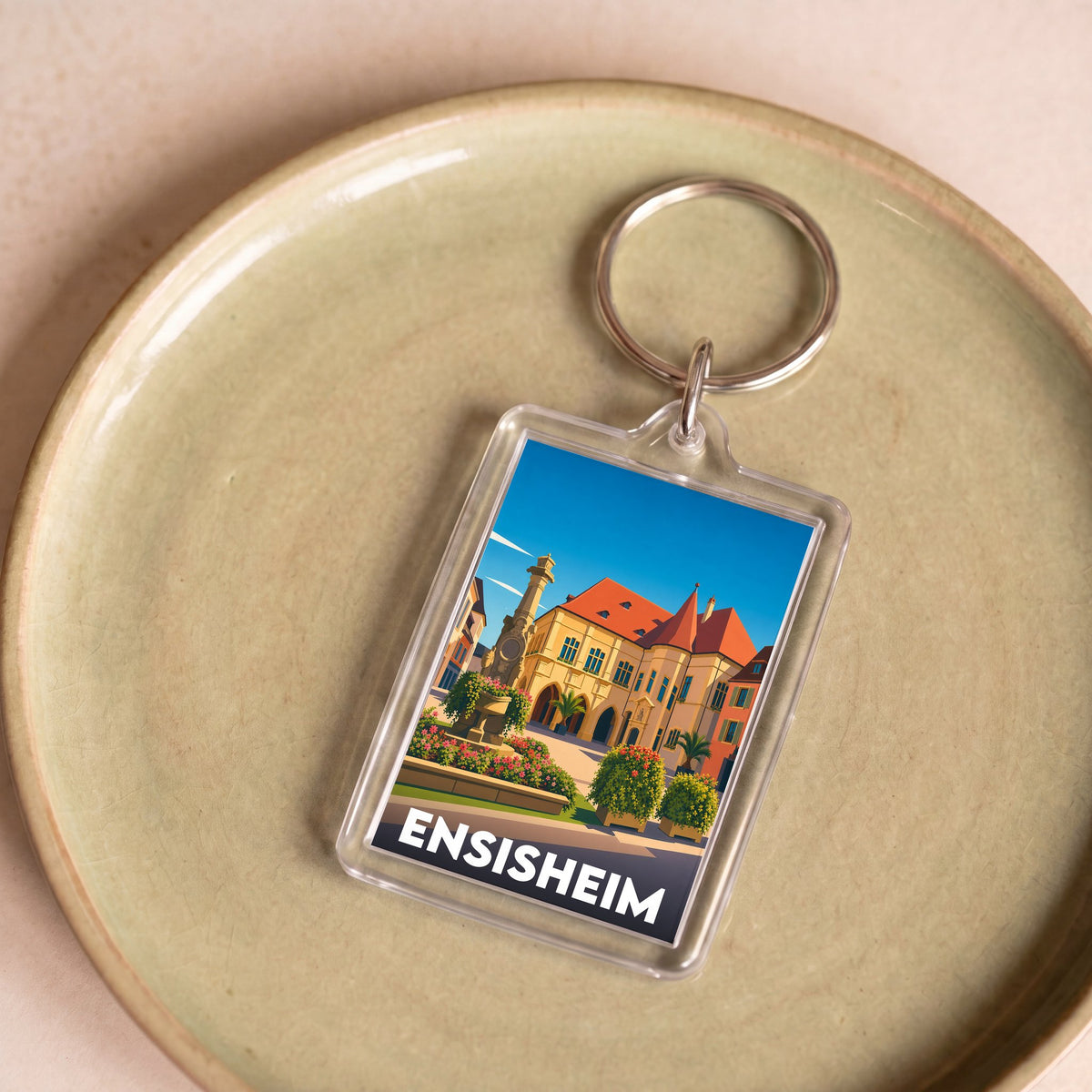 Porte-clés souvenir de la ville d'Ensisheim avec une illustration stylisée.