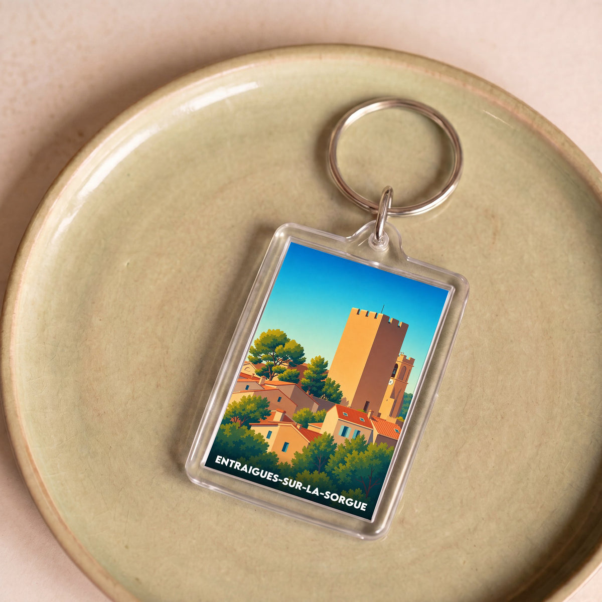 Porte-clés souvenir de la ville de Entraigues-sur-la-Sorgue avec une illustration stylisée.