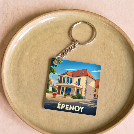Porte-clés souvenir de la ville de Épenoy avec une illustration stylisée de sa mairie.