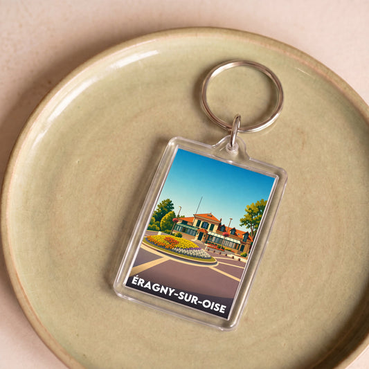 Porte-clés souvenir de la ville d’Éragny-sur-Oise avec une illustration stylisée.