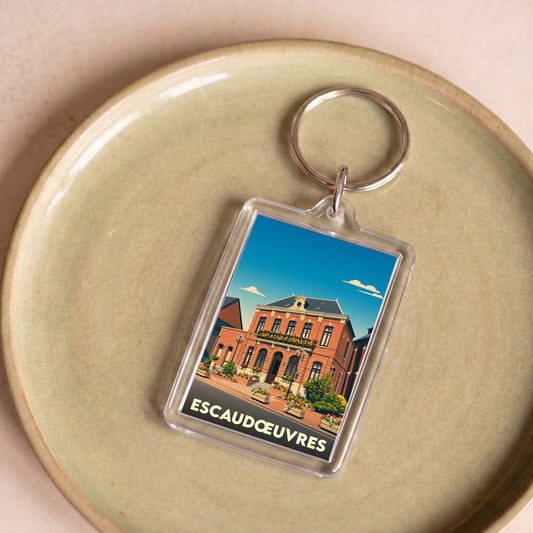 Porte-clés souvenir de la ville d'Escaudœuvres avec une illustration stylisée de son hôtel de ville.