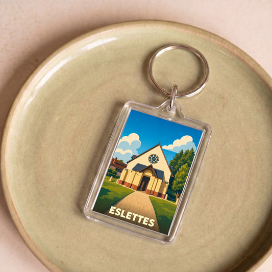 Porte-clés souvenir de la ville d'Eslettes avec une illustration stylisée de son église.