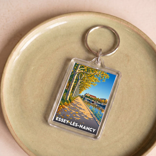 Porte-clés souvenir de la ville d'Essey-lès-Nancy avec une illustration automnale stylisée.