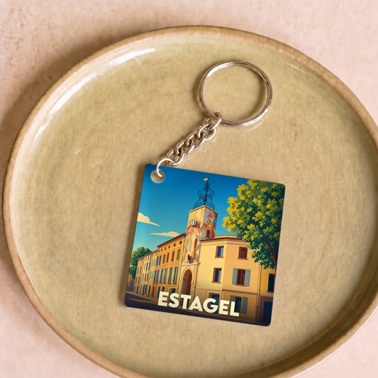 Porte-clés souvenir de la ville de Estagel avec une illustration stylisée et colorée.
