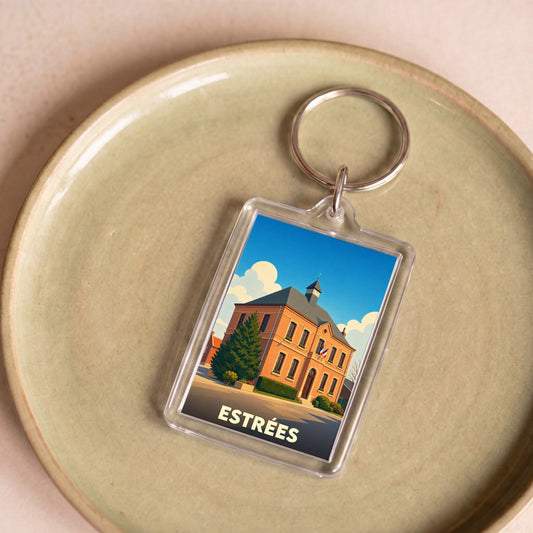 Porte-clés souvenir de la ville d'Estrées avec une illustration stylisée de sa mairie.