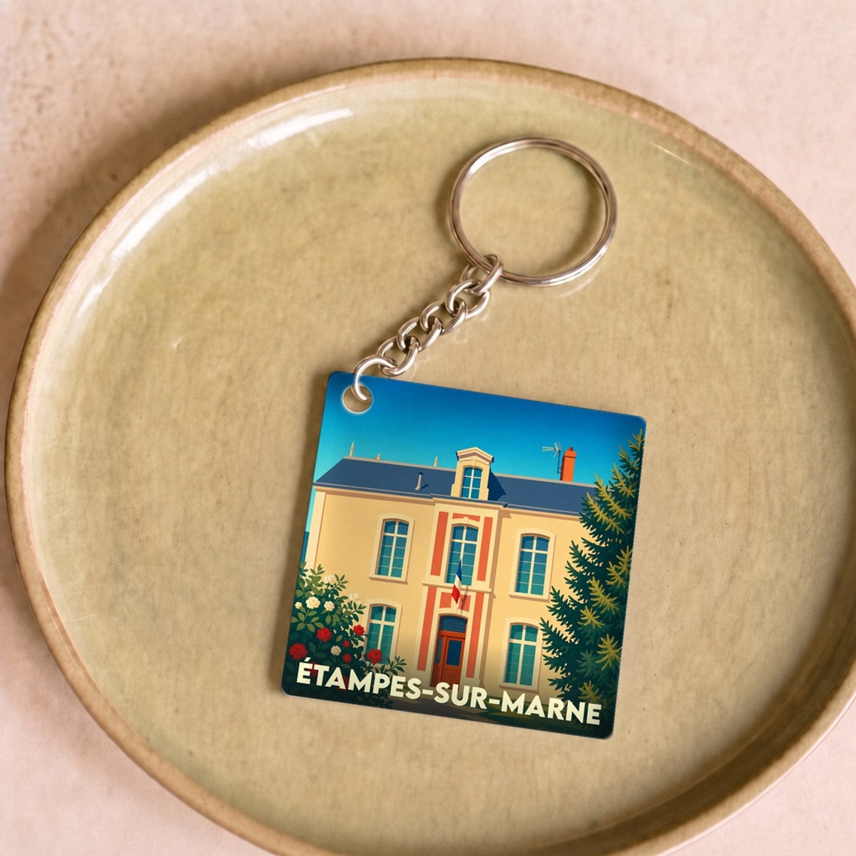 Porte-clés souvenir de la ville de Étampes-sur-Marne avec une illustration stylisée de la mairie.