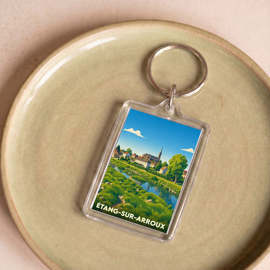 Porte-clés souvenir de la ville d'Étang-sur-Arroux avec une illustration paysagère stylisée.