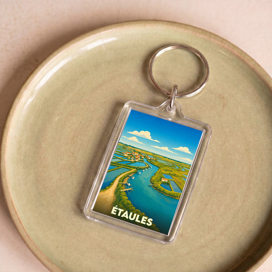 Porte-clés souvenir de la ville d'Étaules avec une illustration stylisée de ses marais.