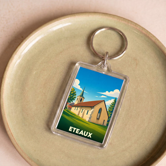 Porte-clés souvenir de la ville d'Eteaux avec une illustration stylisée de son église.