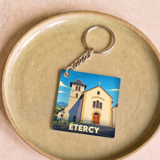 Porte-clés souvenir de la ville d'Étercy avec une illustration stylisée de son église.