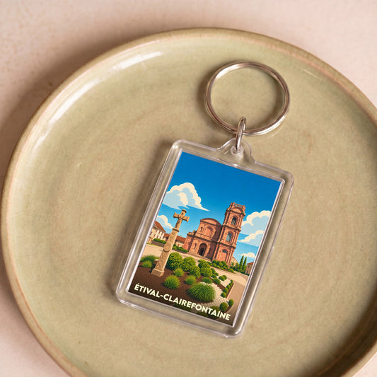 Porte-clés souvenir de la ville d'Étival-Clairefontaine avec une illustration stylisée de son église et de sa croix monumentale.