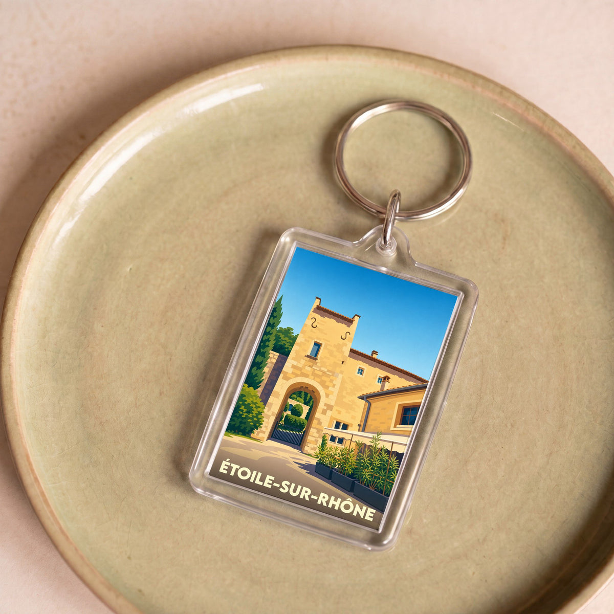 Porte-clés souvenir de la ville d'Étoile-sur-Rhône avec une illustration stylisée.