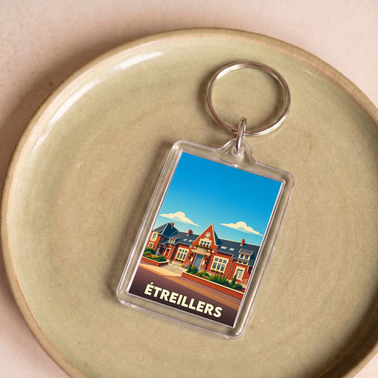 Porte-clés souvenir de la ville d'Étreillers avec une illustration stylisée de son architecture.