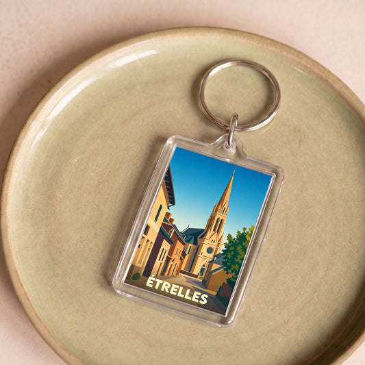 Porte-clés souvenir de la ville d'Étrelles avec une illustration stylisée de son église.