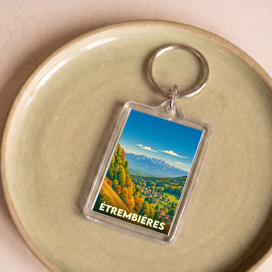 Porte-clés souvenir de la ville d'Étrembières avec une illustration stylisée de paysages montagneux.
