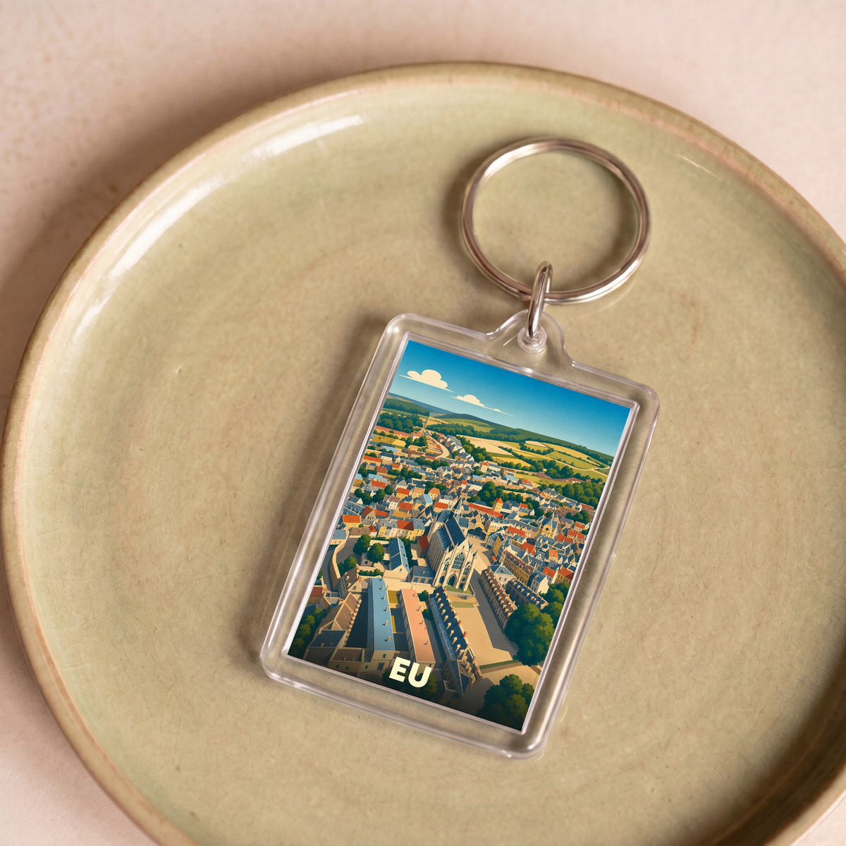 Porte-clés souvenir de la ville de Eu avec une illustration panoramique stylisée.