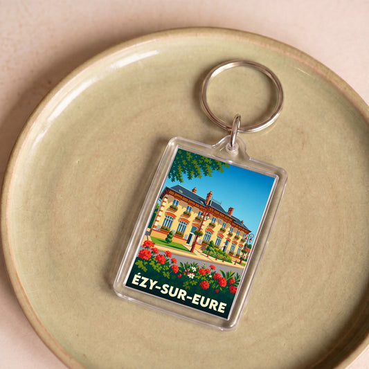 Porte-clés souvenir de la ville d'Ézy-sur-Eure avec une illustration stylisée de sa mairie.
