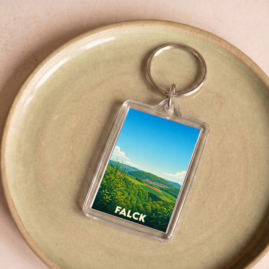 Porte-clés souvenir de la ville de Falck avec une illustration paysagère stylisée.