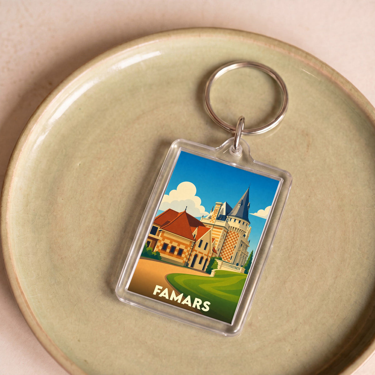 Porte-clés souvenir de la ville de Famars avec une illustration stylisée d'un château.